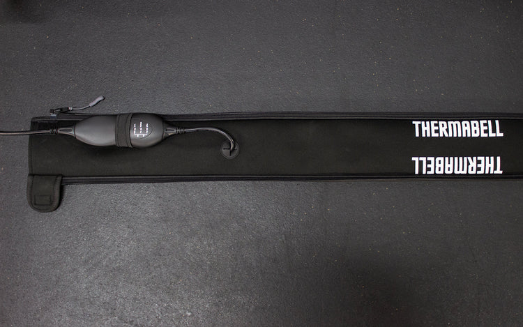 Thermabell Barbell Warmer laid flat on cold home gym floor mats